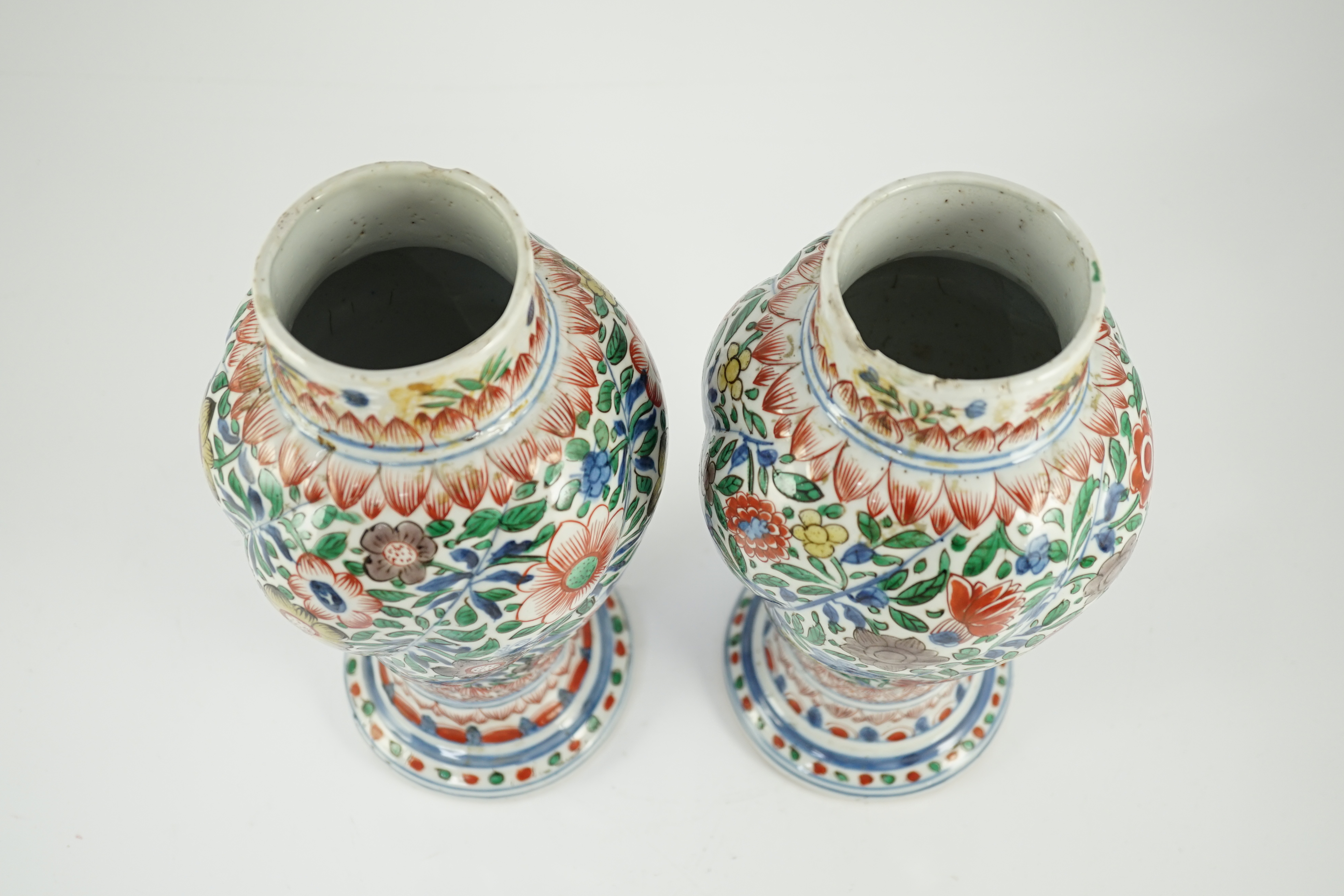 A pair of Chinese wucai spiral lobed baluster vases and covers, Kangxi, c.1680